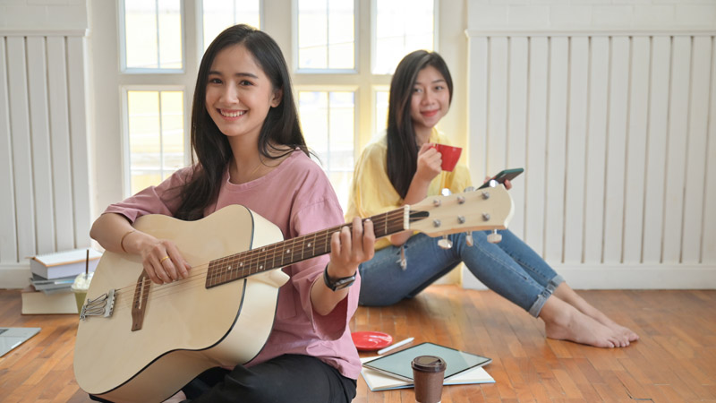 teenage-girls-are-singing-and-playing-guitars-they-NJUHDBF.jpg